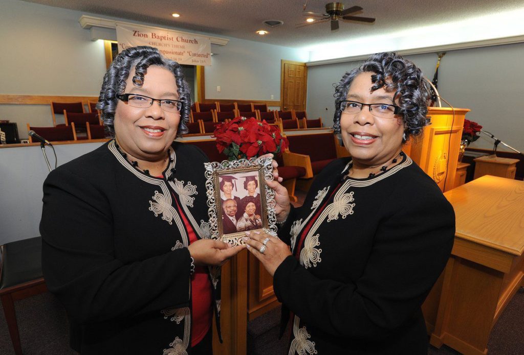 Photo by Alan Warren, Messenger-Inquirer/awarren@messenger-inquirer.com. Twins Berna Bibbs-Snipes, left, and Dorothy Bibbs Kendrick, right, hold up a photograph of their parents, Bernes and Dorothy Hightower Bibbs and their 1977 High School graduation photographers on Tuesday inside the Zion Baptist Church on W. 9th St. The twins have continued the family business at the Bibbs Funeral Home in Greenville. 