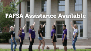 Students pointing to the words FAFSA Assistance Available
