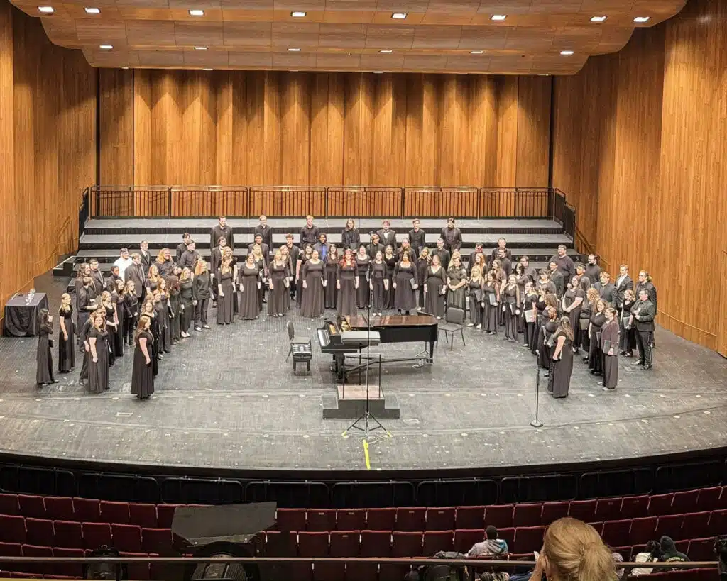 Wesleyan Singers performing in ensemble of 90 students at 2026 KMEA Conference