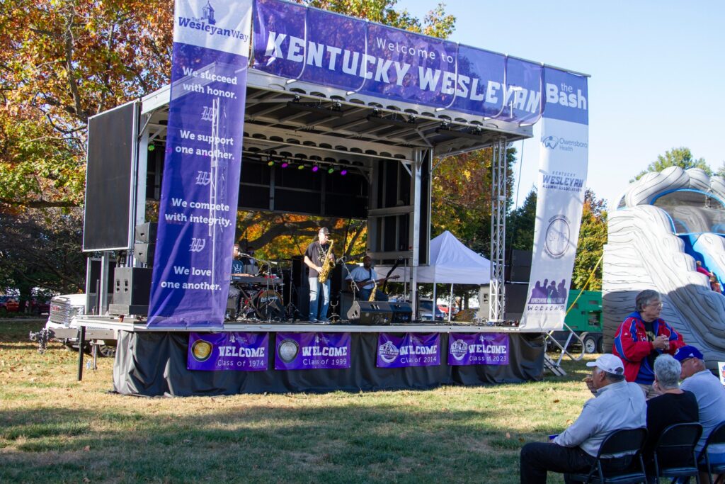 A group of musicians performing on stage at the Kentucky Wesleyan Homecoming and Family weekend