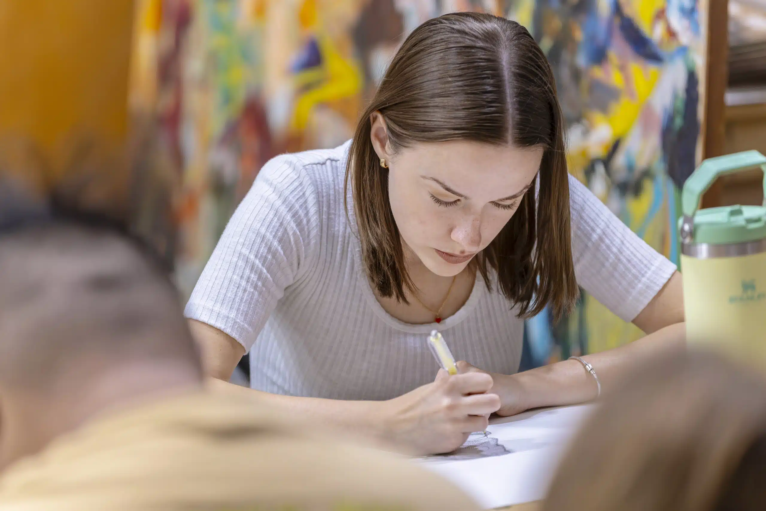 An art student working intently inside the KWC art studio
