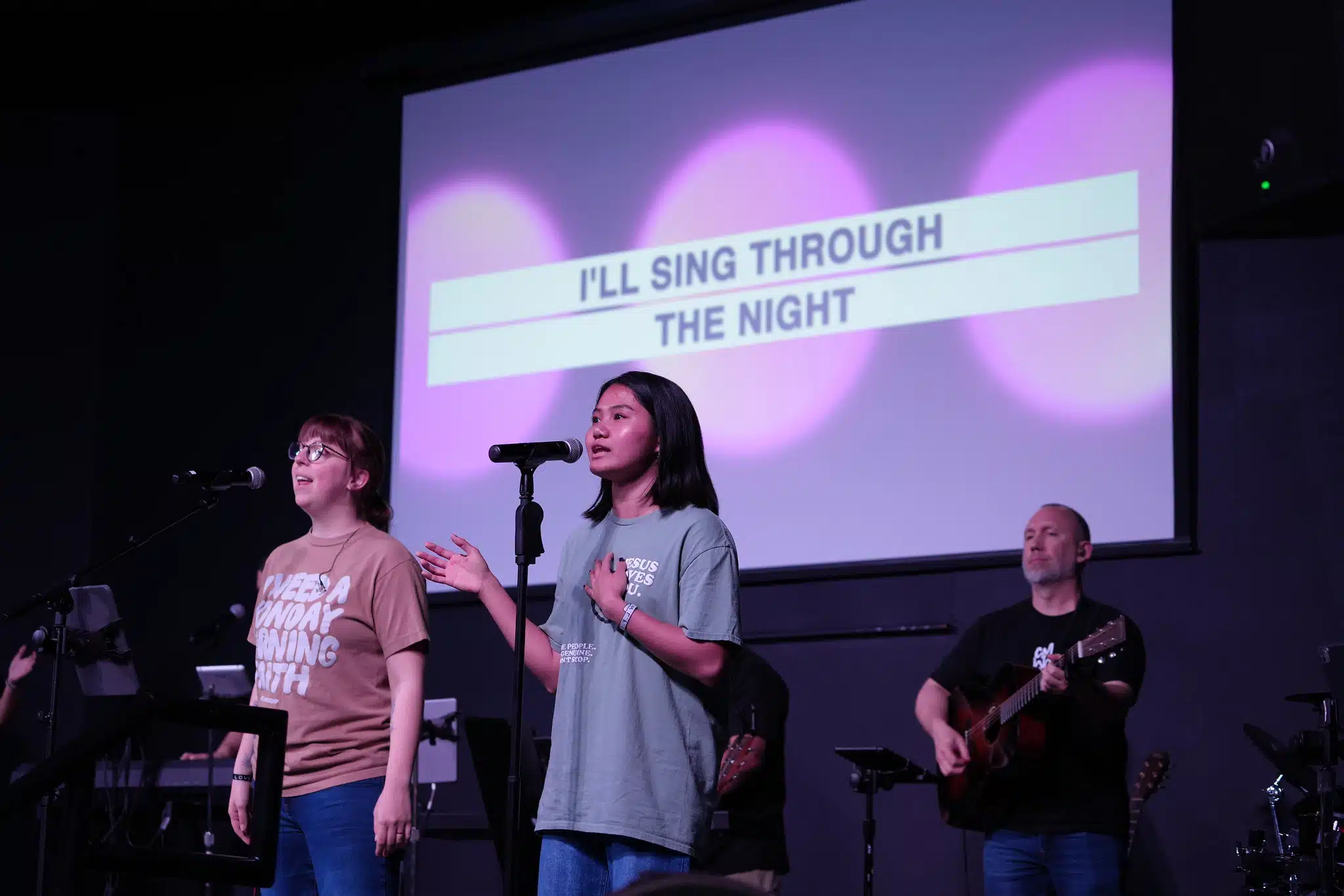 Student leading worship on stage