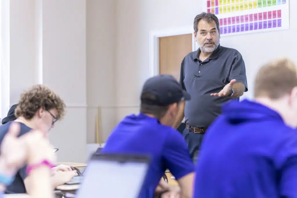 A professor interacts with a classroom of students during lecture