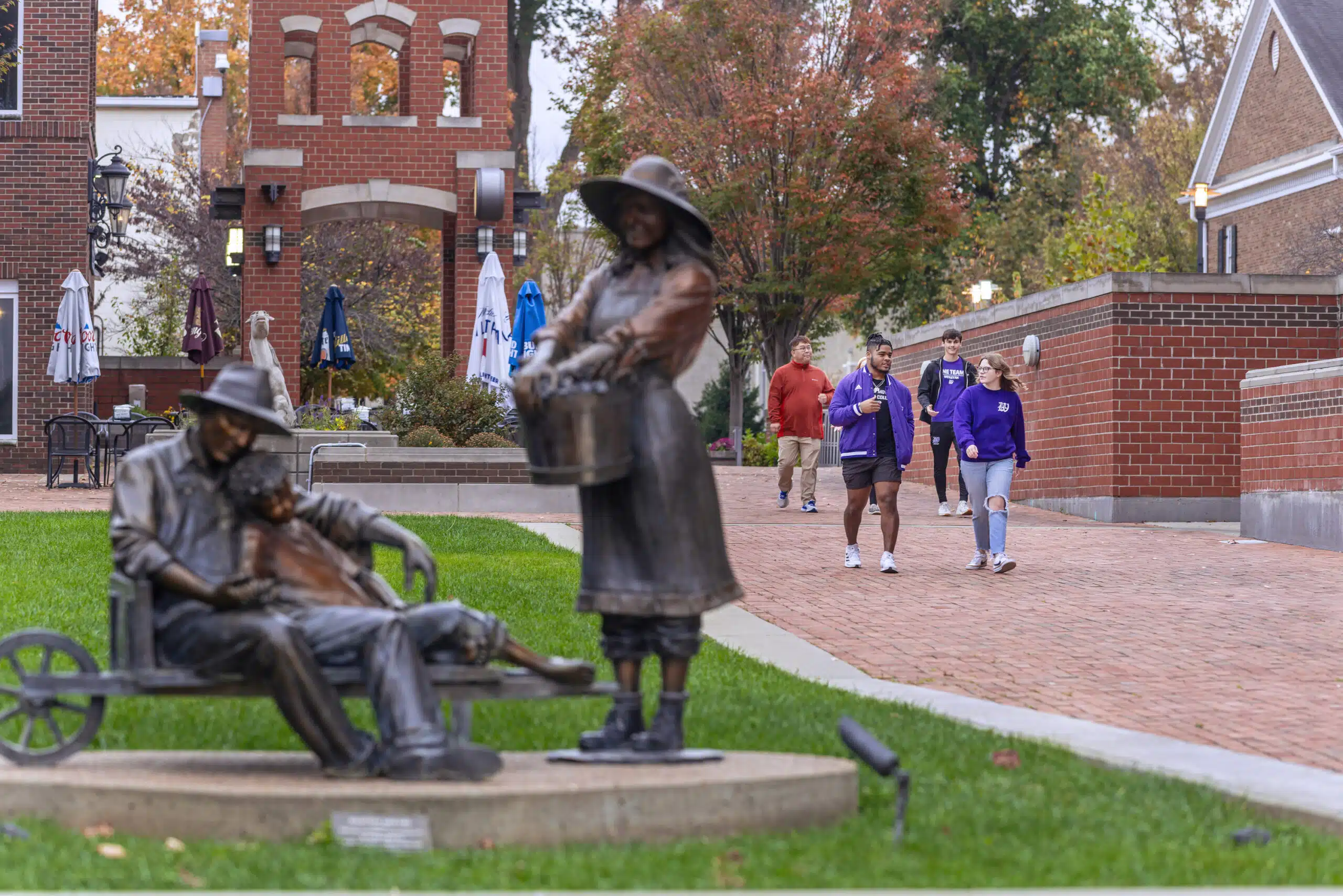 students walking downtown Owensboro near art installation