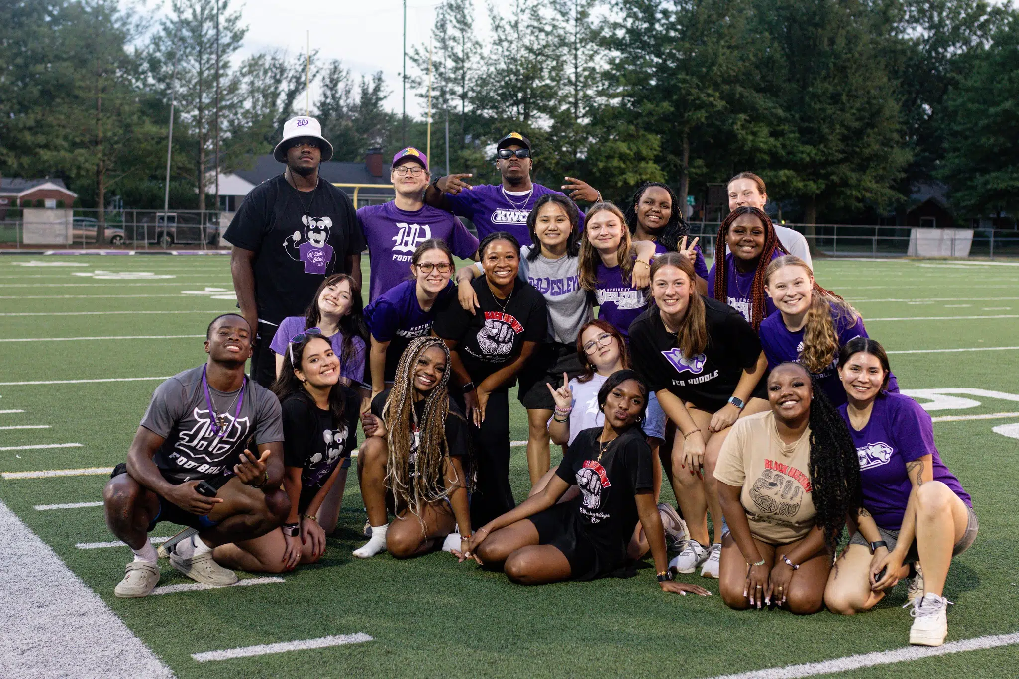 A large group of student orientation leaders happily posing together