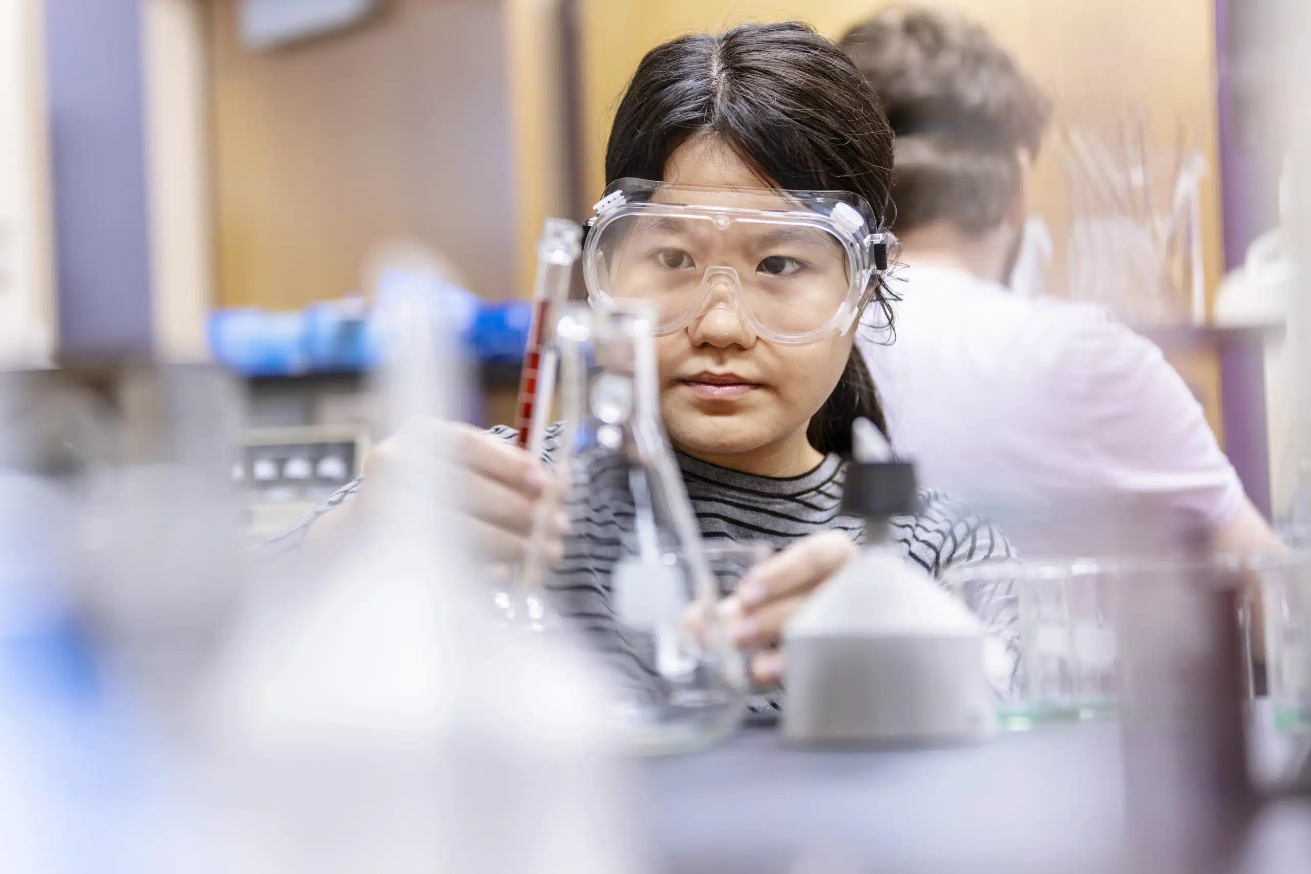 A science lab student working intently on their hands-on activity