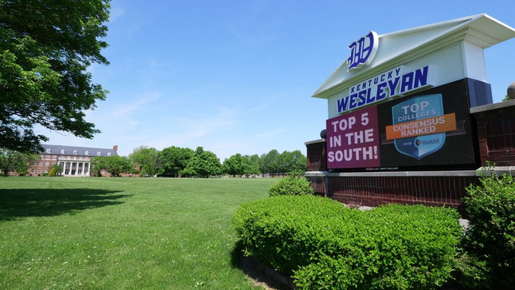 A wide image of the front lawn with the KWC sign on the right side
