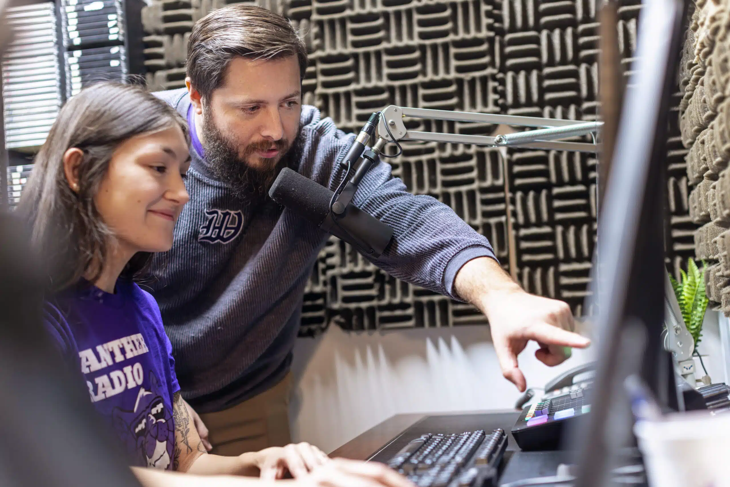 Professor works with student in WKWC studio on campus