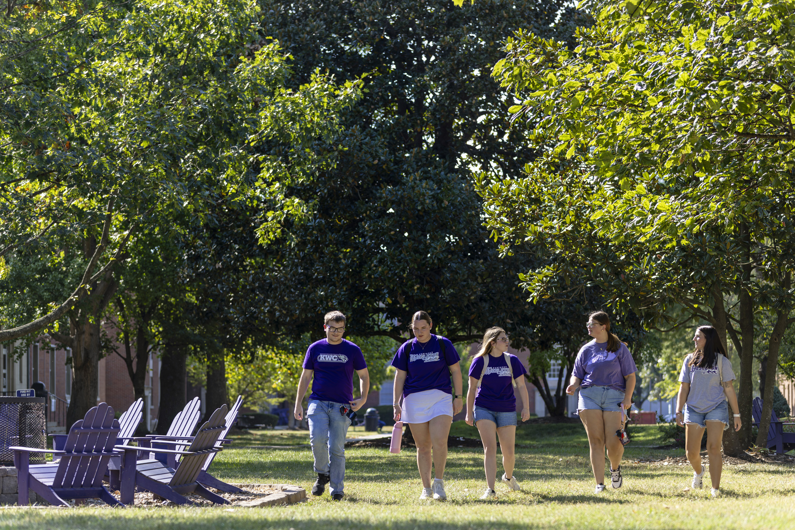 Students walking in the grass on campus outside the residence halls