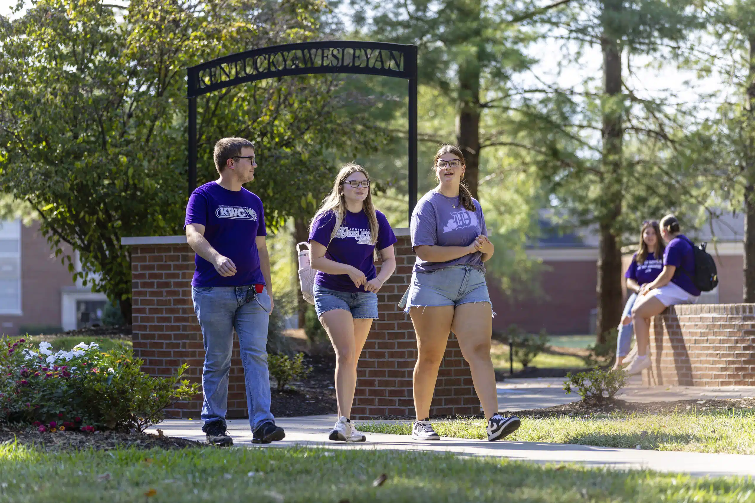 Students walking outside on sidewalks by the residence halls