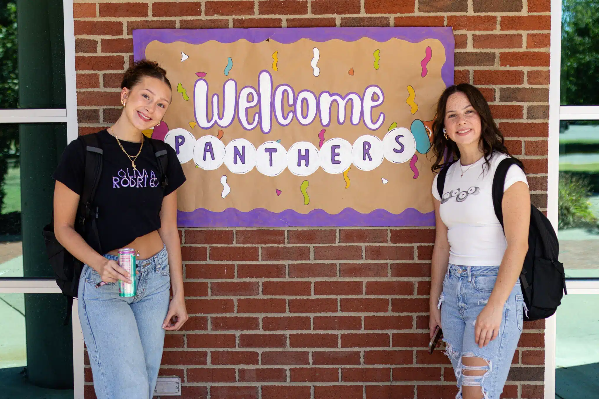 Students posing with Welcome Panthers banner on first day of class